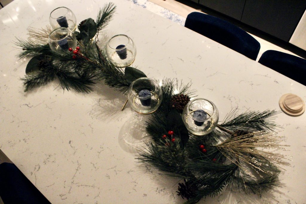 The centerpiece on my kitchen island from West Elm intertwined with holiday garland