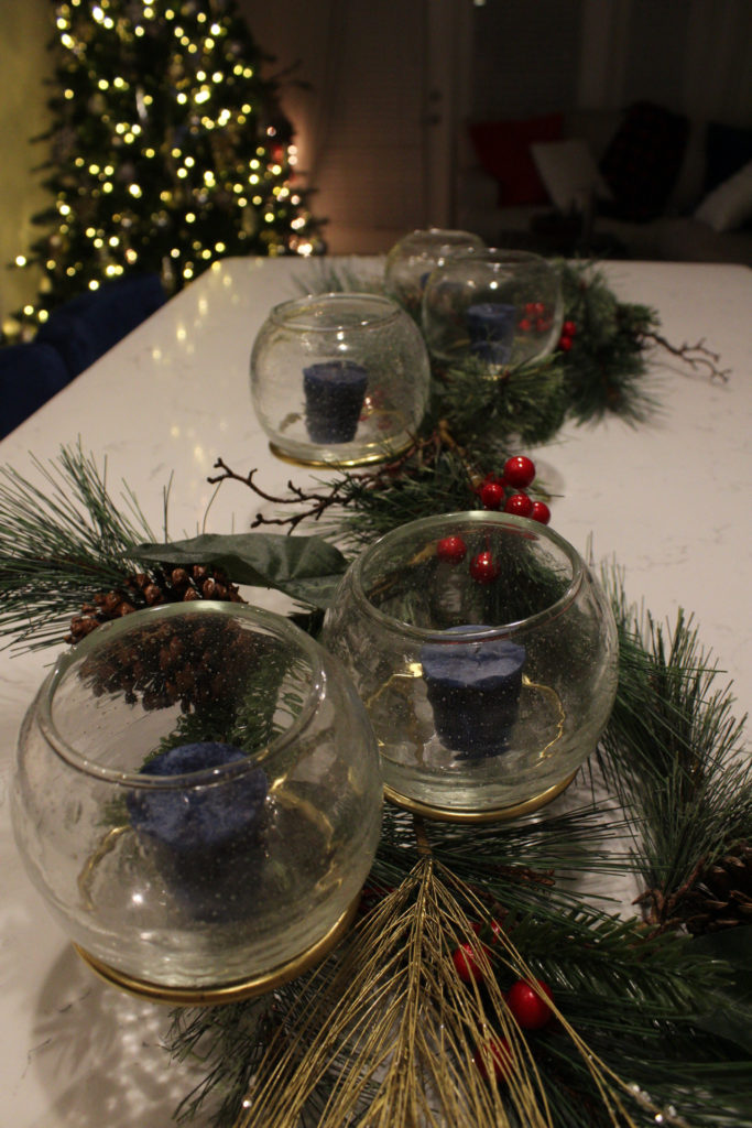 The centerpiece on my kitchen island from West Elm intertwined with holiday garland.